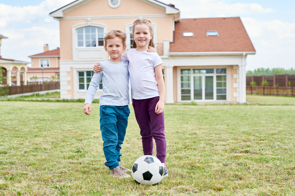 kid siblings photo in front of a house